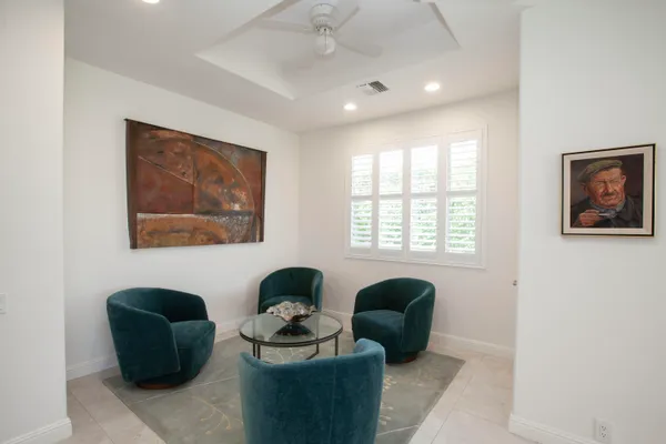 a living room with furniture potted plant and a window