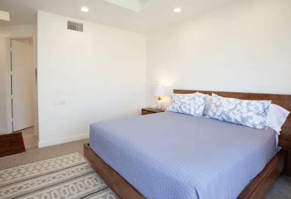 a bedroom with a bed and a rug