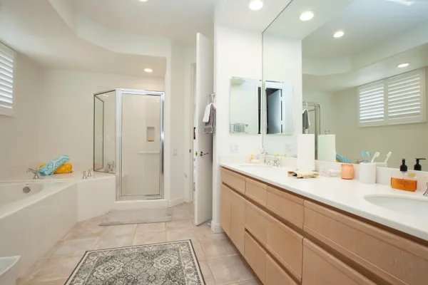 a bathroom with a sink a large mirror and shower