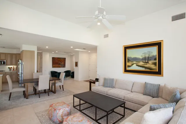 a living room with furniture a table and painting on the wall