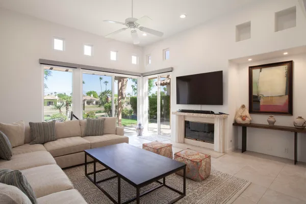 a living room with furniture fireplace and flat screen tv