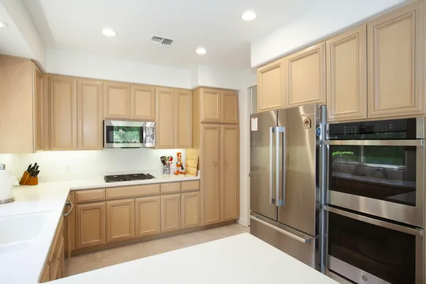 a kitchen with stainless steel appliances a refrigerator sink and cabinets