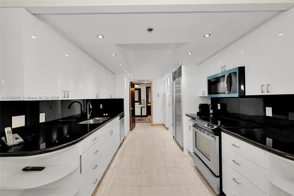 a kitchen with granite countertop a sink and cabinets