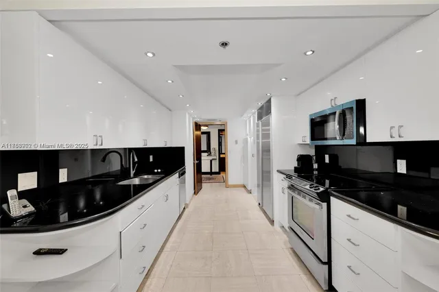 a kitchen with granite countertop a sink and cabinets
