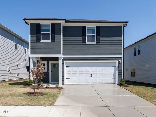 a kitchen with stainless steel appliances granite countertop a sink a stove a refrigerator and white cabinets