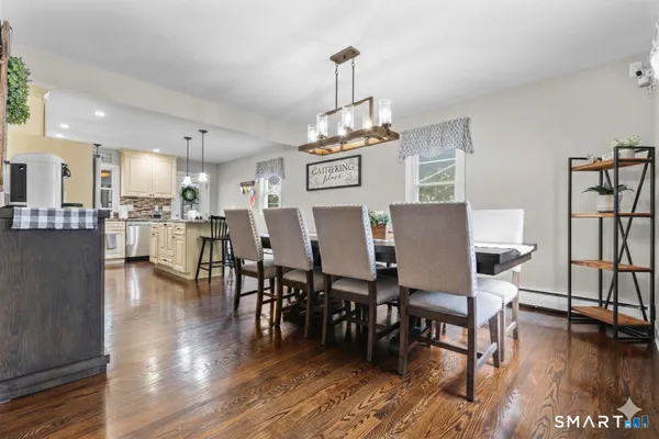 a view of a dining room with furniture and wooden floor
