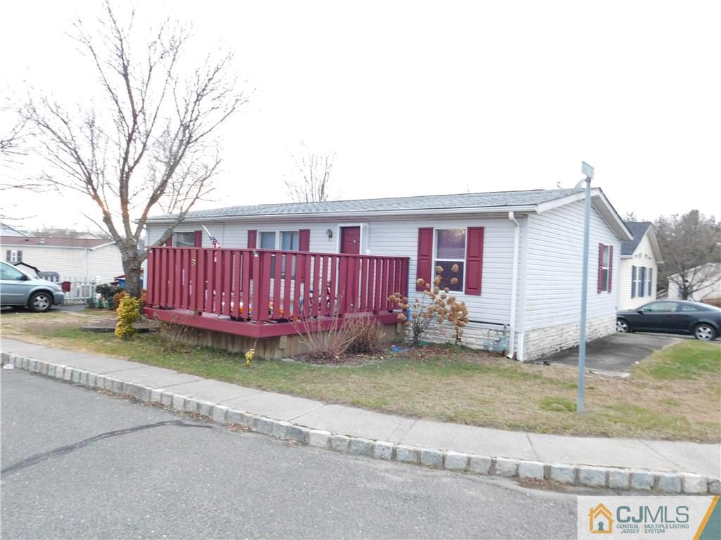 8 Ruffian Way, Unit 8 Howell, NJ 07731 - Photo 3 of 12 a view of a house with a yard and garage