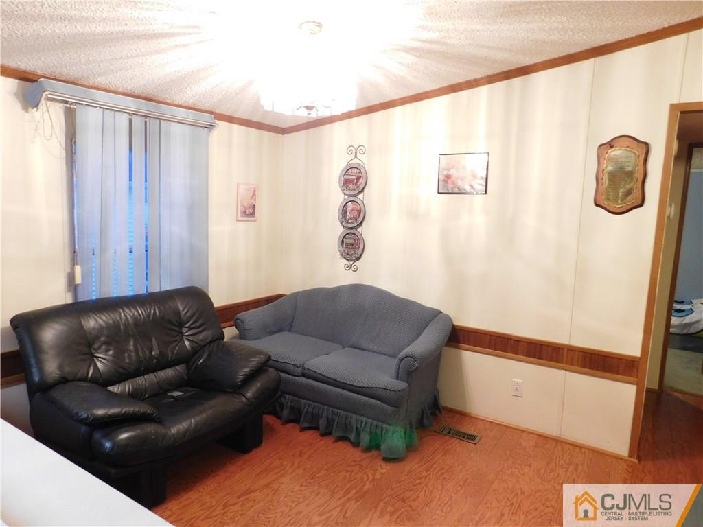 8 Ruffian Way, Unit 8 Howell, NJ 07731 - Photo 9 of 12 a living room with couch and a door