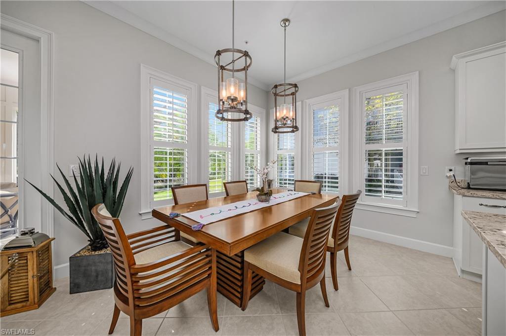 6552 Dominica Drive, Unit 101 Naples, FL 34113 - Photo 11 of 50 a dining room with furniture a chandelier and window