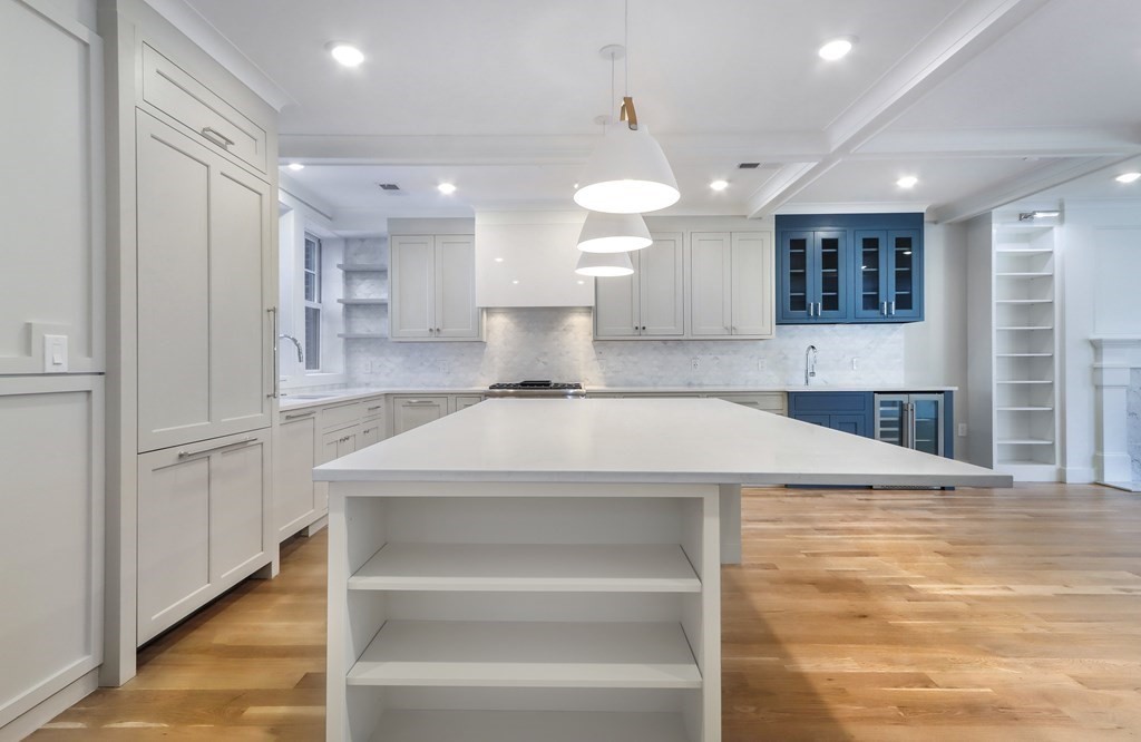 189 Babcock Street, Unit 2 Brookline, MA 02446 - Photo 17 of 39 a large white kitchen with kitchen island a sink stainless steel appliances and cabinets