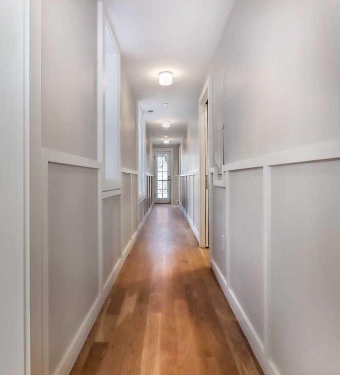 189 Babcock Street, Unit 2 Brookline, MA 02446 - Photo 19 of 39 a view of a hallway with wooden floor
