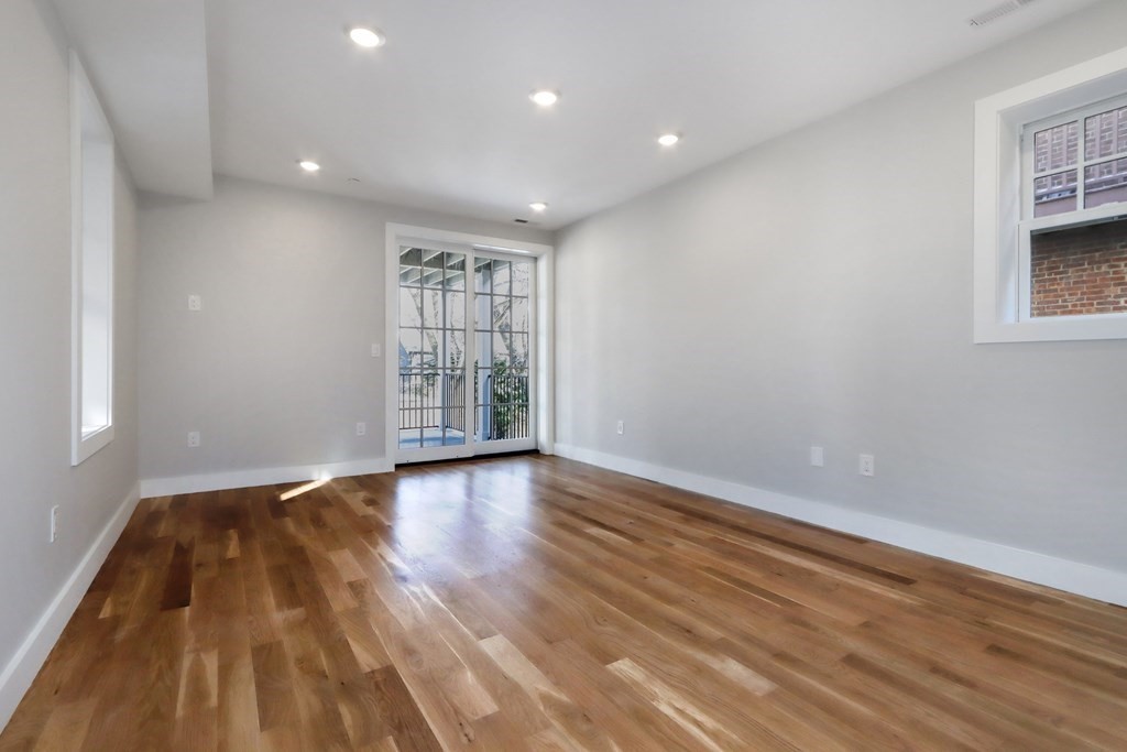 189 Babcock Street, Unit 2 Brookline, MA 02446 - Photo 20 of 39 wooden floor in an empty room with a window