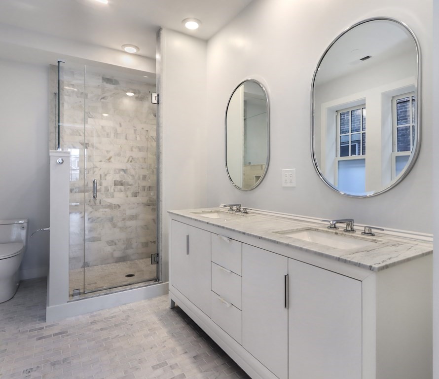 189 Babcock Street, Unit 2 Brookline, MA 02446 - Photo 23 of 39 a bathroom with a double vanity sink mirror and shower