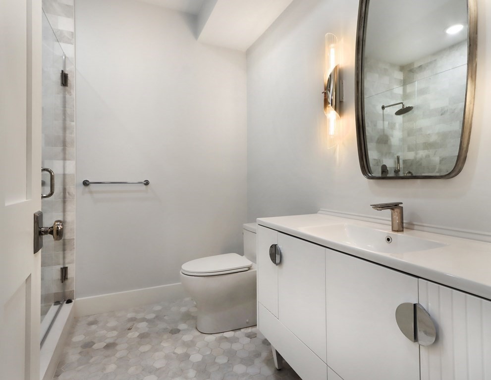 189 Babcock Street, Unit 2 Brookline, MA 02446 - Photo 27 of 39 a bathroom with a sink and a mirror