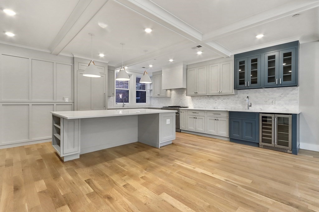 189 Babcock Street, Unit 2 Brookline, MA 02446 - Photo 9 of 39 a kitchen with kitchen island a sink stainless steel appliances and cabinets