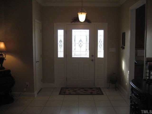 665 Cole Road Clayton, NC 27520 - Photo 2 of 12 Large foyer with coat closet, laminate tile flooring and beautiful front door.