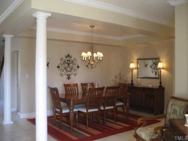 665 Cole Road Clayton, NC 27520 - Photo 3 of 12 Dining Room with columns, tray ceiling with beadboard and laminate tile flooring.