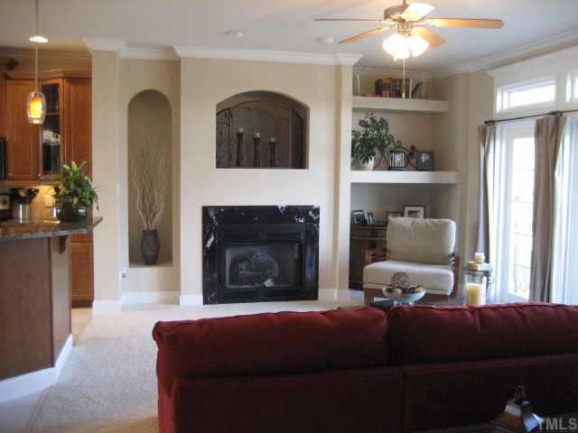 665 Cole Road Clayton, NC 27520 - Photo 4 of 12 Another view of the living room with gas log fireplace w/blower and built-ins on each side.
