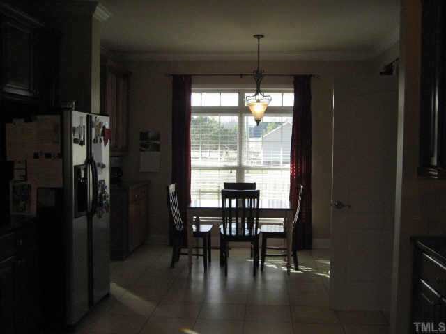 665 Cole Road Clayton, NC 27520 - Photo 6 of 12 Breakfast nook with built-in cabinet and laminate tile flooring.