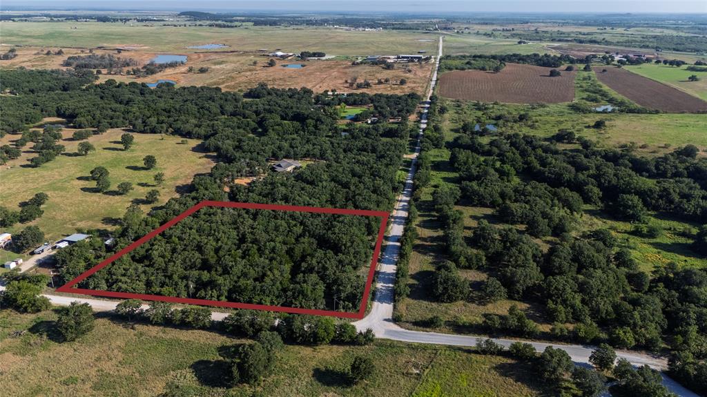an aerial view of a houses with a lake view