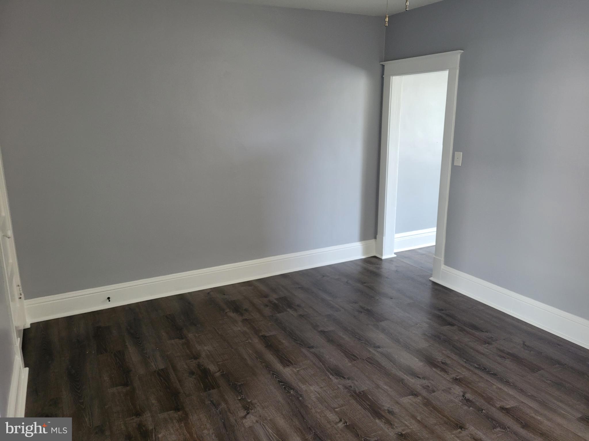6757 Woodley Road Dundalk, MD 21222 - Photo 11 of 27 a view of an empty room with wooden floor