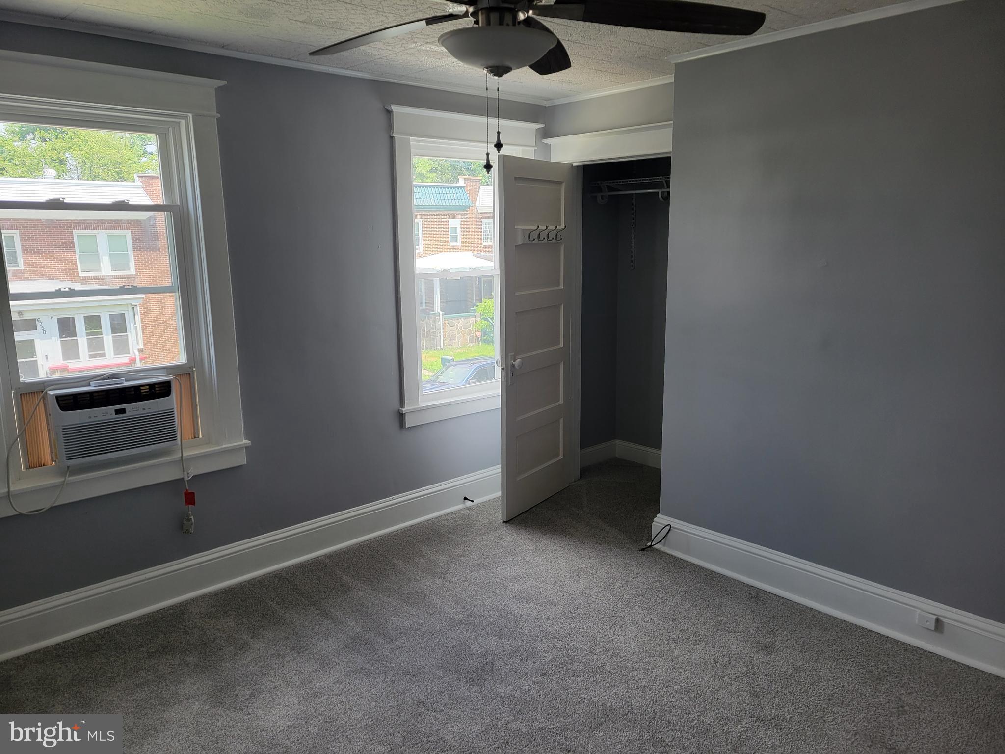 6757 Woodley Road Dundalk, MD 21222 - Photo 20 of 27 an empty room with a window and a ceiling fan