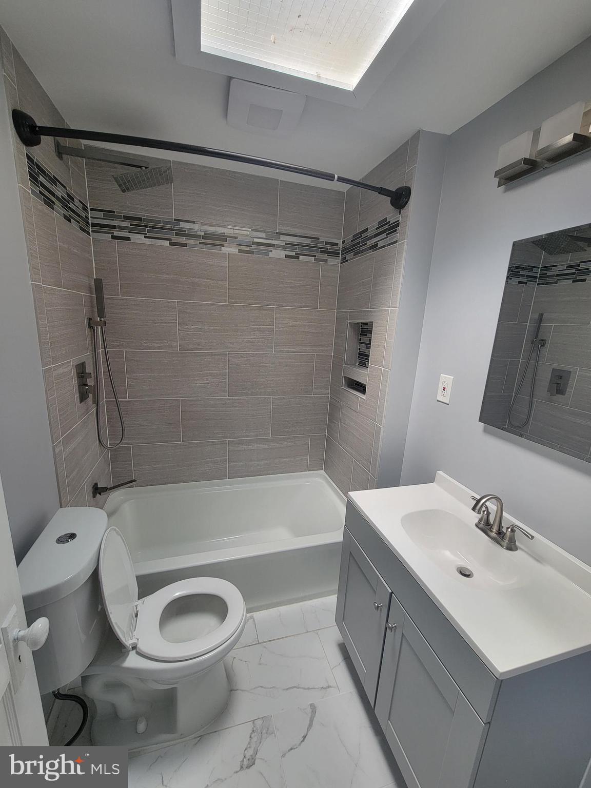6757 Woodley Road Dundalk, MD 21222 - Photo 21 of 27 a bathroom with a sink toilet and shower