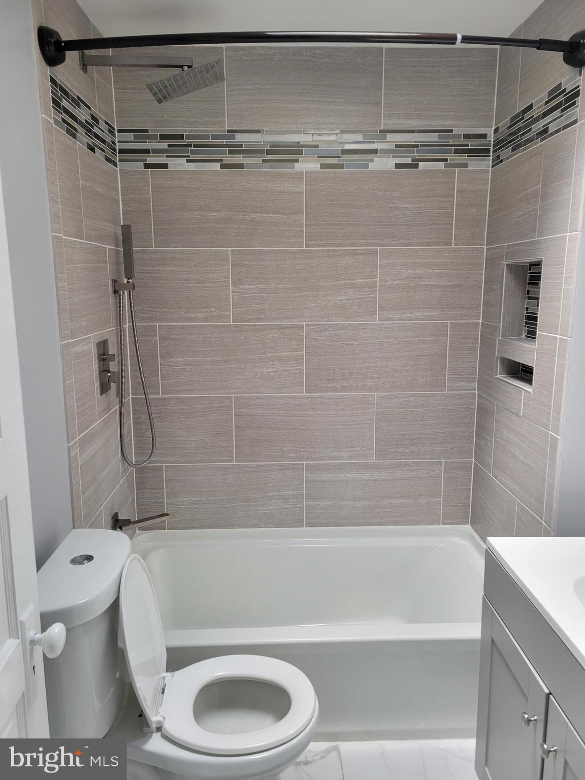 6757 Woodley Road Dundalk, MD 21222 - Photo 22 of 27 a bathroom with a toilet and a shower