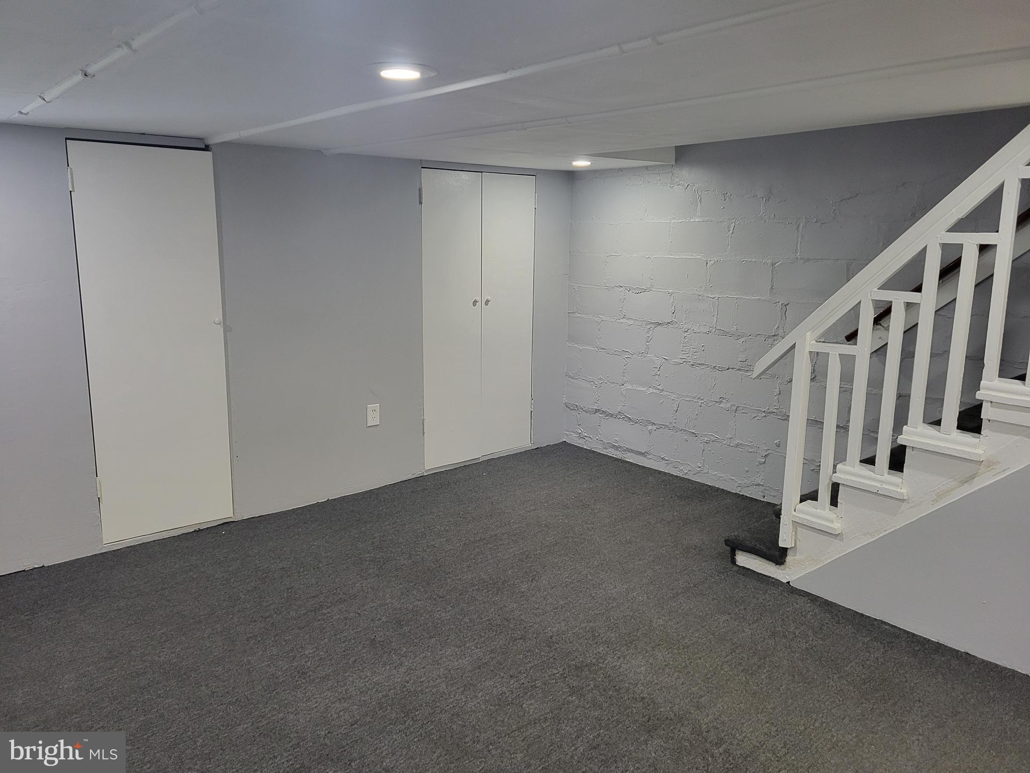 6757 Woodley Road Dundalk, MD 21222 - Photo 26 of 27 a view of an empty room with stairs