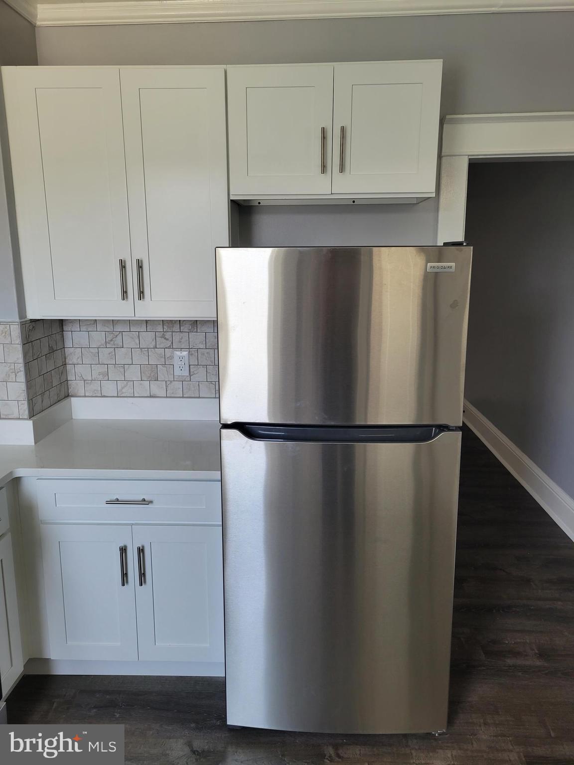 6757 Woodley Road Dundalk, MD 21222 - Photo 4 of 27 a white refrigerator freezer sitting in a kitchen