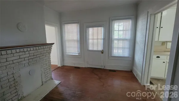 a view of an entryway with wooden floor