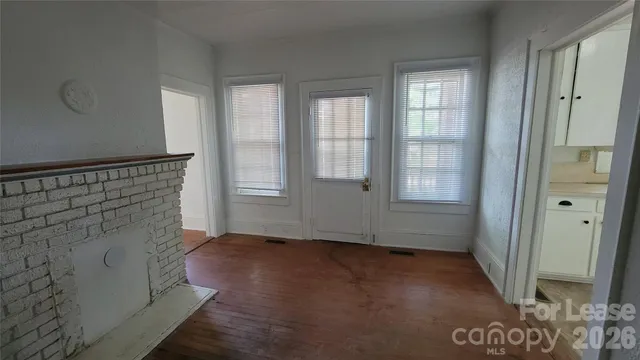 a view of an entryway with wooden floor