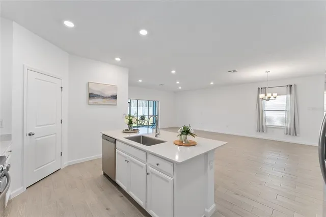 a view of hallway with sink and mirror
