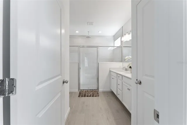 a bathroom with a shower and a sink