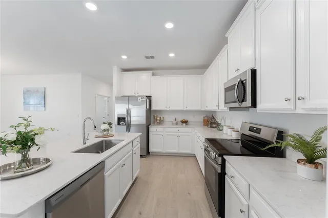 a kitchen with a sink stove and refrigerator
