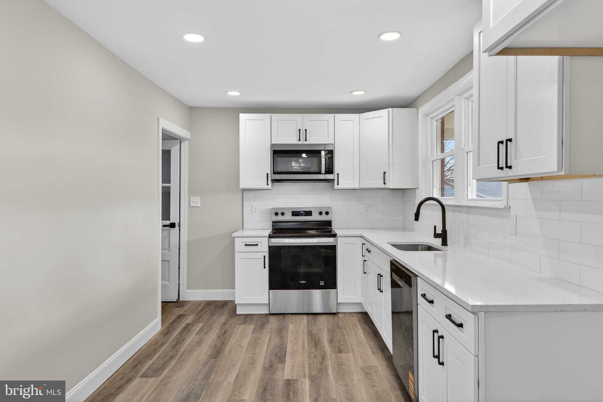 5960 Clover Road Harrisburg, PA 17112 - Photo 12 of 39 a kitchen with granite countertop white cabinets and stainless steel appliances