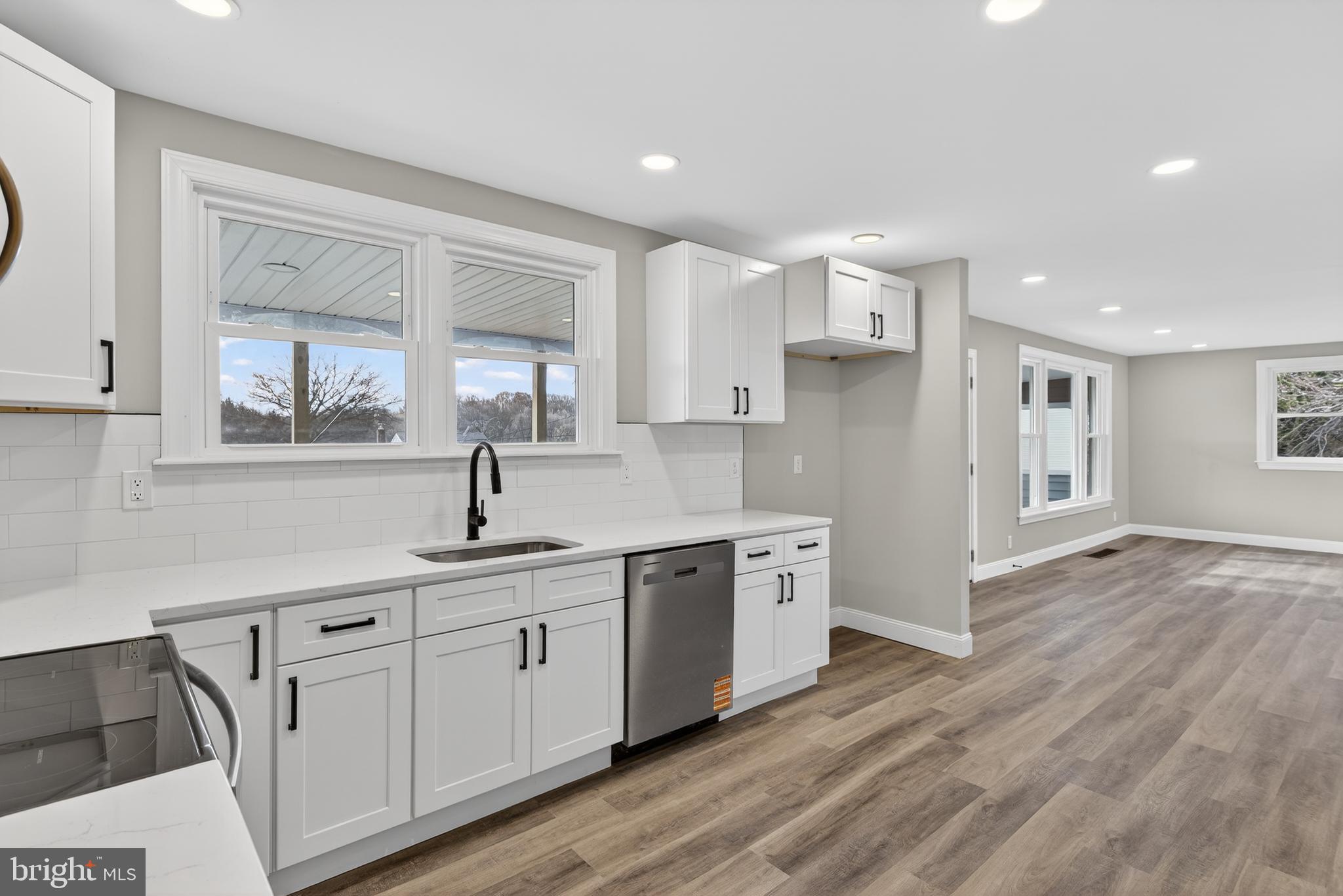 5960 Clover Road Harrisburg, PA 17112 - Photo 13 of 39 a kitchen with white cabinets and wooden floors