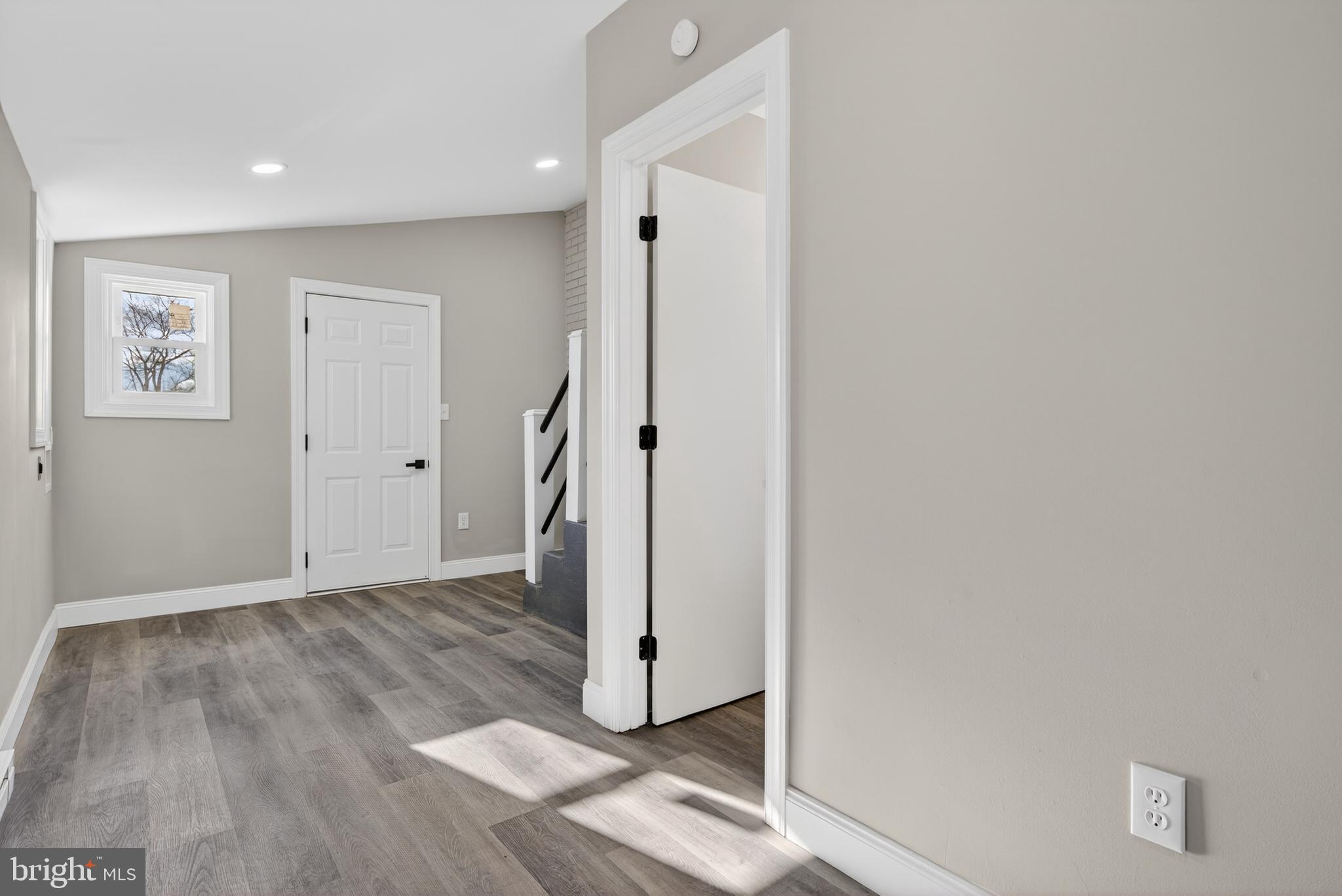 5960 Clover Road Harrisburg, PA 17112 - Photo 14 of 39 a view of an empty room with wooden floor and a hallway
