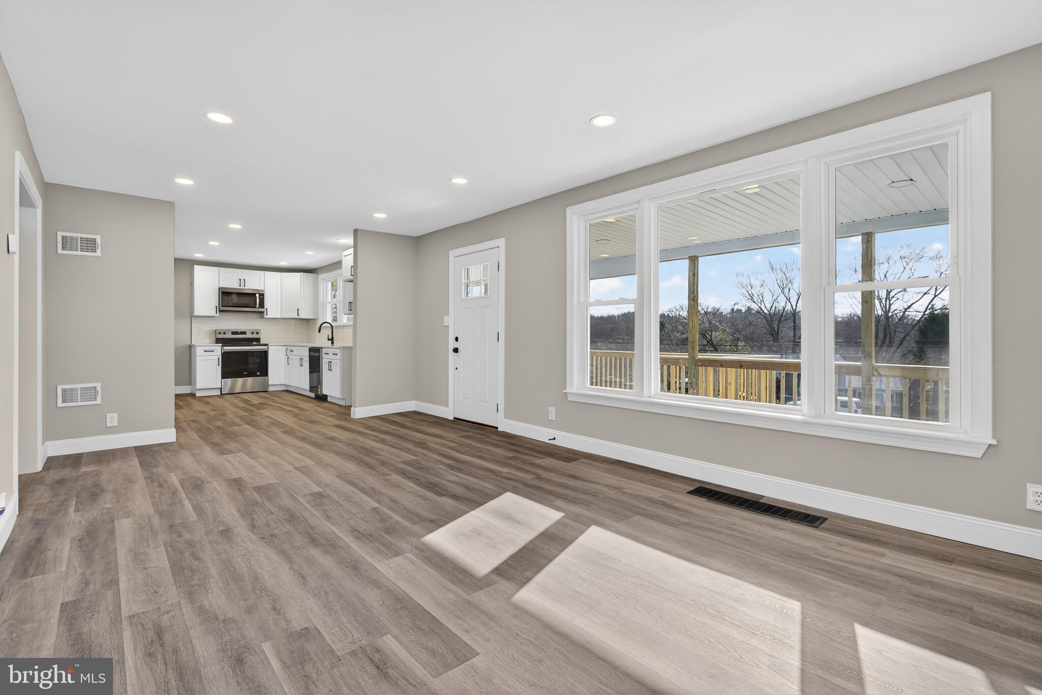5960 Clover Road Harrisburg, PA 17112 - Photo 9 of 39 a view of an empty room with a window and a kitchen