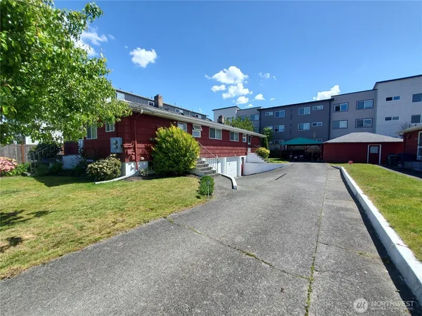 a front view of house with yard and outdoor seating