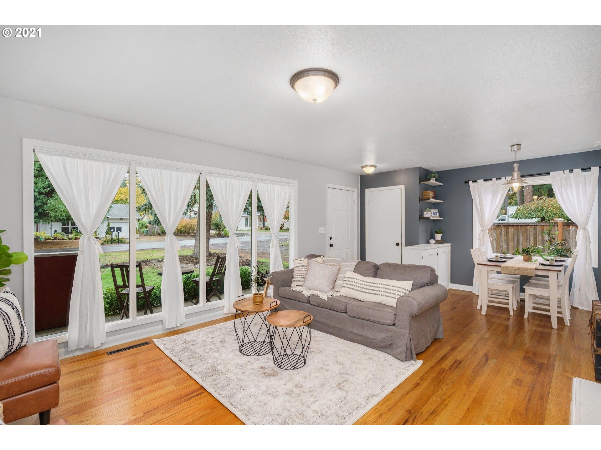 7408 Southwest Mapleleaf Street Portland, OR 97223 - Photo 5 of 32 a living room with furniture large window and rug