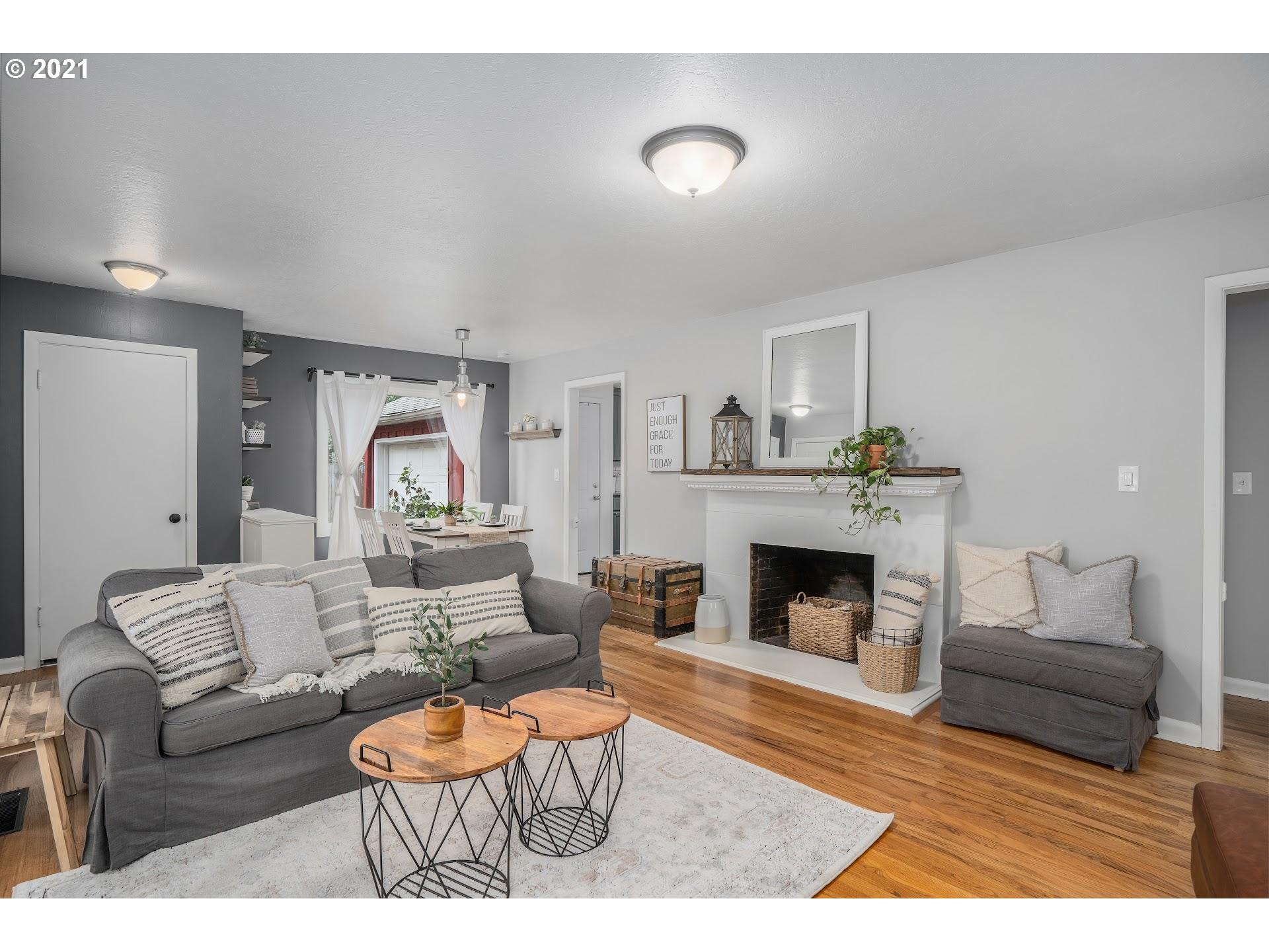 7408 Southwest Mapleleaf Street Portland, OR 97223 - Photo 6 of 32 a living room with furniture and a fireplace