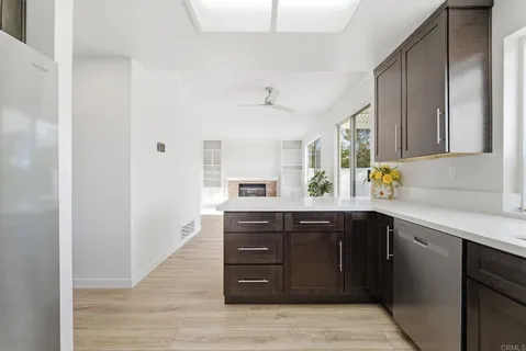 a kitchen with stainless steel appliances granite countertop a sink and cabinets