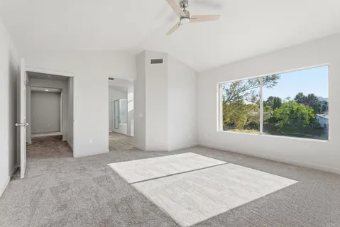 an empty room with windows and closet