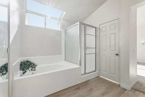 a bathroom with a bathtub and shower