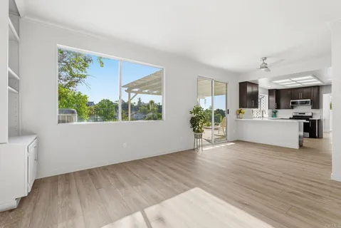 a view of a living room hardwood floor and a window