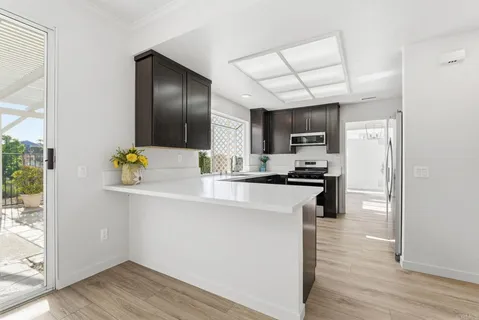 a kitchen with a refrigerator and a stove top oven