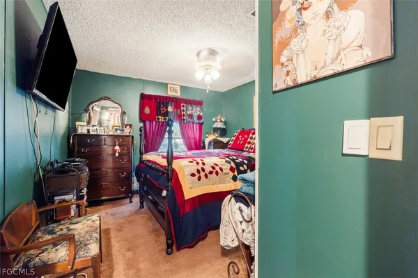 a bedroom with a bed closet and window
