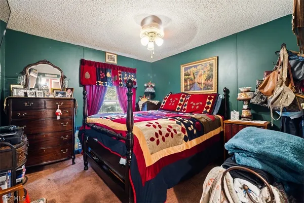 a bedroom with bed and a chandelier