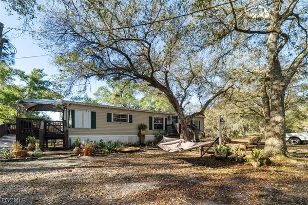 a view of a house with a yard covered in snow